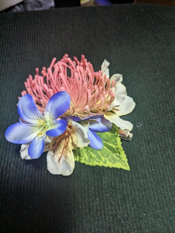 Pink Protea. blue Lily of the Nile and white plumeria