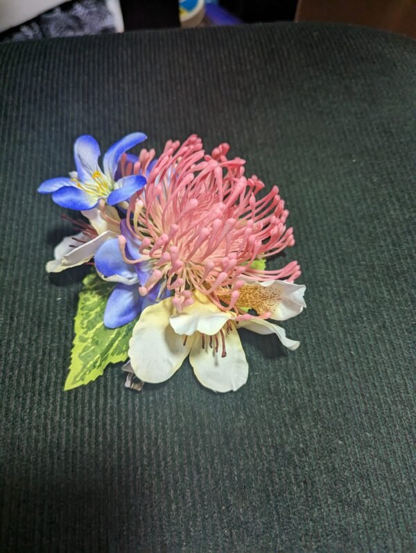 Pink Protea. blue Lily of the Nile and white plumeria